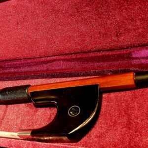 A double bass bow inside a red case